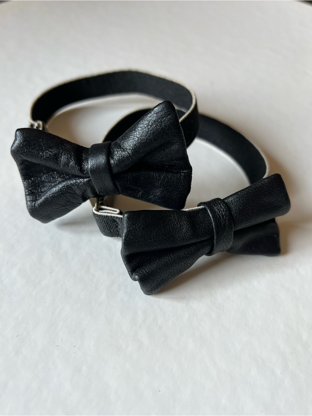 Set of Two Black Leather Bow Elastic Sleeve Holders